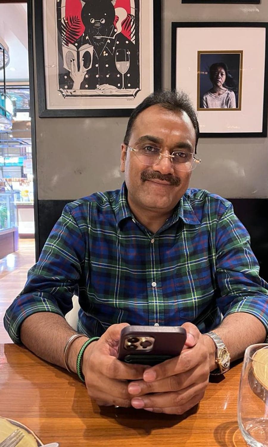 Rakesh Sharma seated at a table, smiling